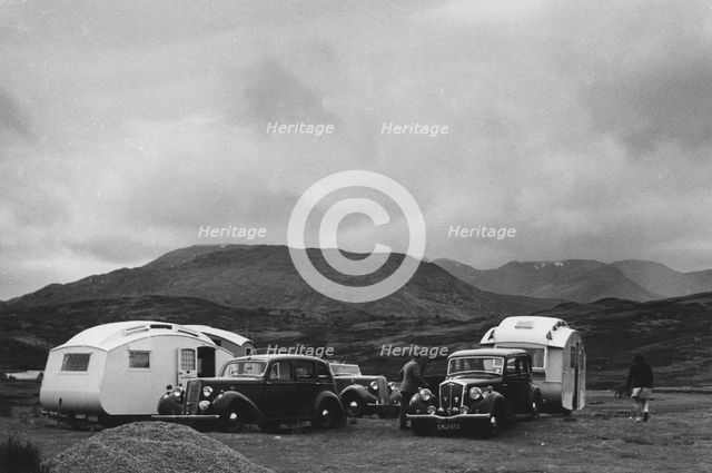 Group of cars and caravans camping in Scottish Highlands 1930's. Creator: Unknown.