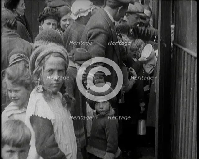 Group of Children Walking Out of a Food Kitchen With Bread And Soup, 1924. Creator: British Pathe Ltd.