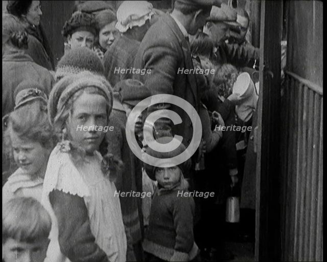 Group of Children Walking Out of a Food Kitchen With Bread And Soup, 1924. Creator: British Pathe Ltd.