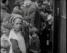 Group of Children Walking Out of a Food Kitchen With Bread And Soup, 1924. Creator: British Pathe Ltd