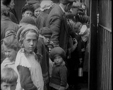 Group of Children Walking Out of a Food Kitchen With Bread And Soup, 1924. Creator: British Pathe Ltd