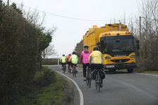 Group of cylists encounter refuse truck on country road in New Forest 2014