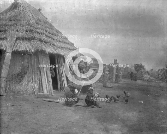 Group of Ainu outside a hut, 1908. Creator: Arnold Genthe.