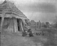 Group of Ainu outside a hut, 1908. Creator: Arnold Genthe