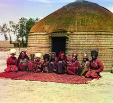 Group of eleven adults and children, seated on a rug, in front of a yurt, between 1905 and 1915. Creator: Sergey Mikhaylovich Prokudin-Gorsky
