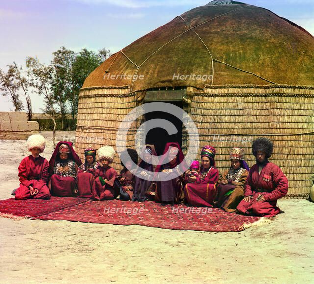 Group of eleven adults and children, seated on a rug, in front of a yurt, between 1905 and 1915. Creator: Sergey Mikhaylovich Prokudin-Gorsky.