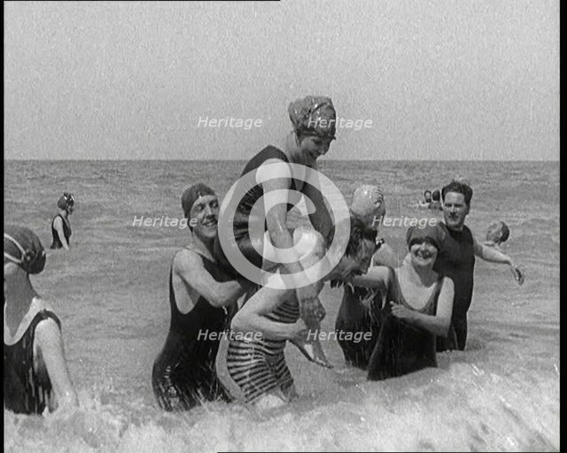 Group of Four Female Civilians and One Male Civilian in Bathing Suits Playing in the Sea..., 1924. Creator: British Pathe Ltd.