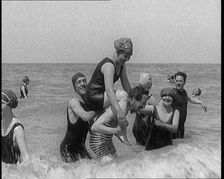 Group of Four Female Civilians and One Male Civilian in Bathing Suits Playing in the Sea..., 1924. Creator: British Pathe Ltd