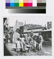 Group of freedmen, including children, gathered by a canal in Richmond, Virginia, c1865. Creator: Unknown