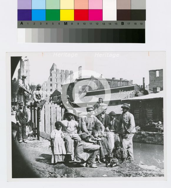 Group of freedmen, including children, gathered by a canal in Richmond, Virginia, c1865. Creator: Unknown.