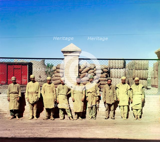 Group of labourers in front of a chain-link fence, between 1905-1915. Creator: Sergey Mikhaylovich Prokudin-Gorsky.