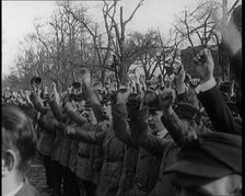 Group of Male Civilians Standing and Cheering With Their Fists Raised in the Air, 1924. Creator: British Pathe Ltd