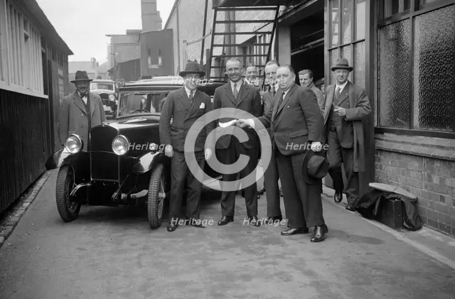 Group of men with a Triumph Super Seven, c1930(?). Artist: Bill Brunell.