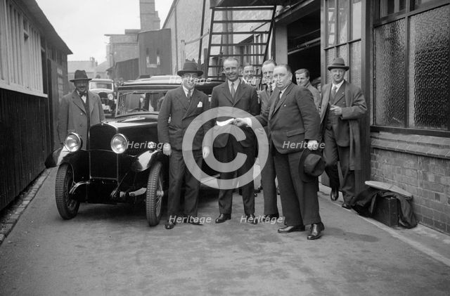 Group of men with a Triumph Super Seven, c1930(?). Artist: Bill Brunell.