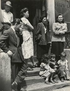 Group of men, women and children gathered on stoop, East Harlem, New York City, 1947 - 1951. Creator: Romulo Lachatanere