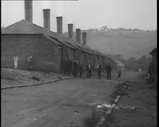 Group of Men, Women and Children Standing Around on a Street, 1933. Creator: British Pathe Ltd
