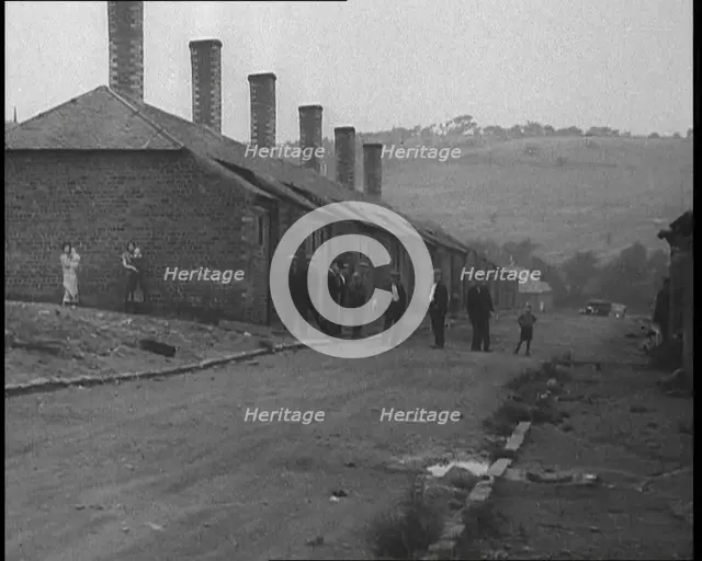 Group of Men, Women and Children Standing Around on a Street, 1933. Creator: British Pathe Ltd.