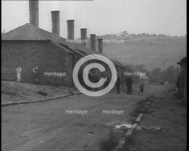 Group of Men, Women and Children Standing Around on a Street, 1933. Creator: British Pathe Ltd.