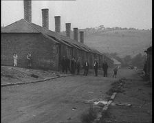 Group of Men, Women and Children Standing Around on a Street, 1933. Creator: British Pathe Ltd