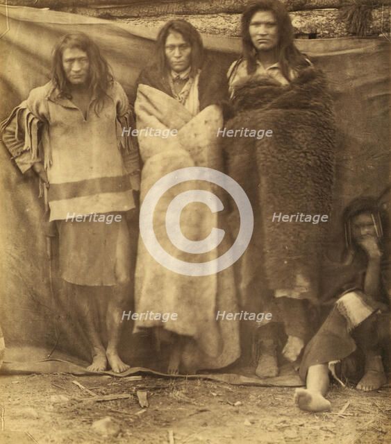 Group of Native Americans, three standing, one seated on the ground, possibly..., 1860 or 1861. Creator: Unknown.