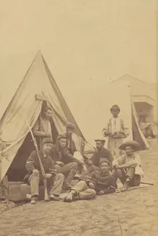Group of seven soldiers and one black servant at a campsite, about 1862. Creator: Mathew Brady
