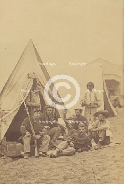 Group of seven soldiers and one black servant at a campsite, about 1862. Creator: Mathew Brady.
