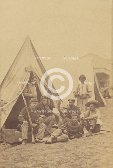Group of seven soldiers and one black servant at a campsite, about 1862. Creator: Mathew Brady.