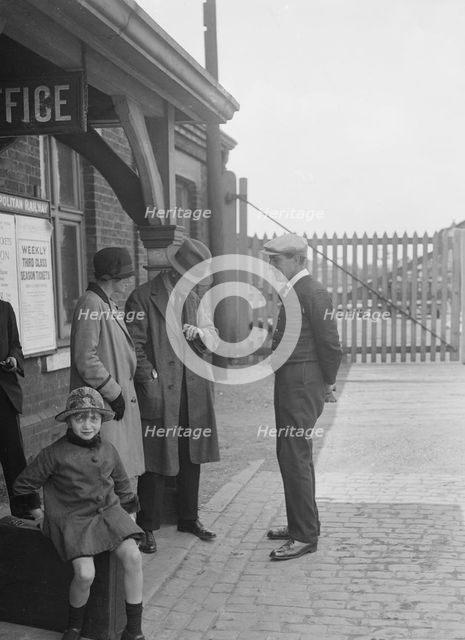 Group of people outside a Metropolitan Line railway station, London, 1930s.   Artist: Bill Brunell.