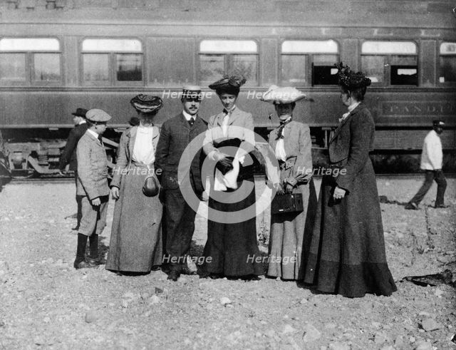 Group of people posed with railroad car behind them, Denver, Colorado, (1903?). Creator: Frances Benjamin Johnston.