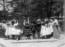 Group of public school children offering peanuts to animals in the Nation..., Washington DC, (1899?) Creator: Frances Benjamin Johnston