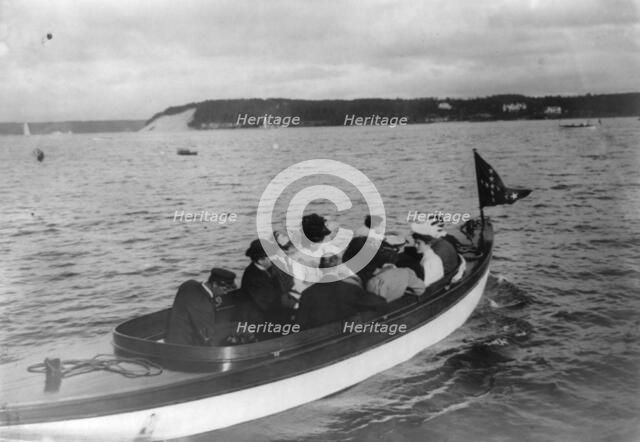 Group of well-dressed men and women in motorboat, Oyster Bay, Long Island, N.Y., 1905. Creator: Frances Benjamin Johnston.
