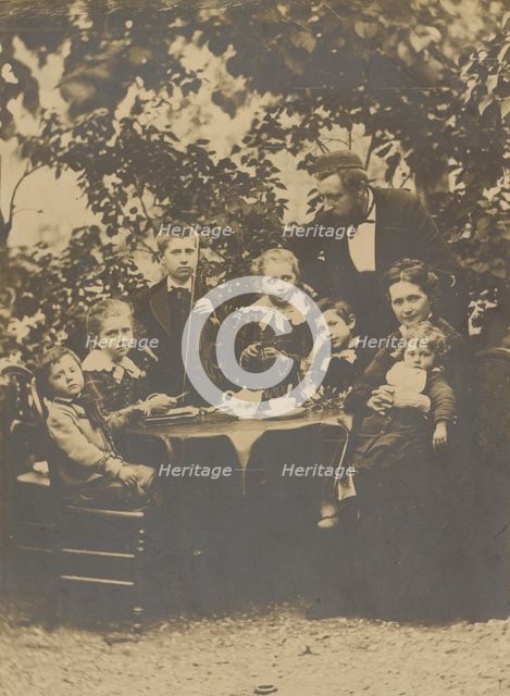 Group portrait around table, 1880-1890. Creator: Victor Dix.