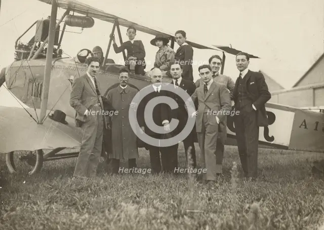 Group portrait in front of plane, 1915-1930. Creator: Fédèle Azari.