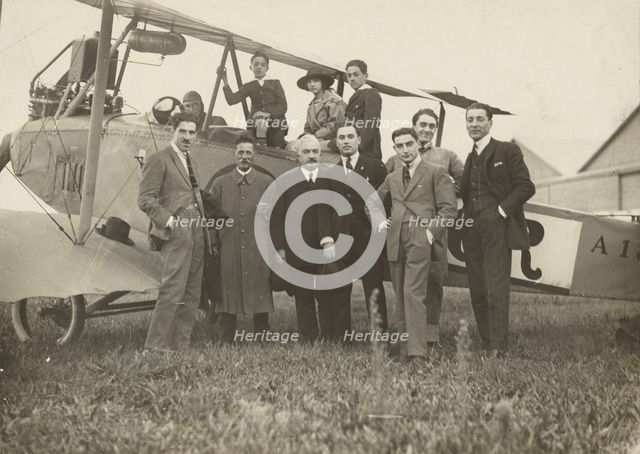 Group portrait in front of plane, 1915-1930. Creator: Fédèle Azari.