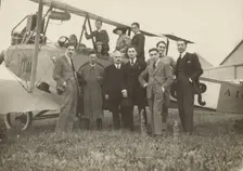 Group portrait in front of plane, 1915-1930. Creator: Fédèle Azari