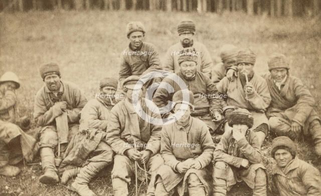 Group portrait of convicts seated in a field, between 1880 and 1886. Creator: Unknown.