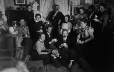 Group portrait of friends at social gathering, seated and standing with tea cups..., c1890 - 1910. Creator: Frances Benjamin Johnston