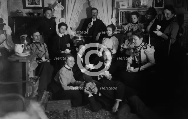 Group portrait of friends at social gathering, seated and standing with tea cups..., c1890 - 1910. Creator: Frances Benjamin Johnston.