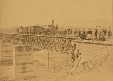 Group portrait with train on bridge, 1865. Creator: Altobelli & Molins