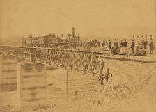 Group portrait with train on bridge, 1865. Creator: Altobelli & Molins