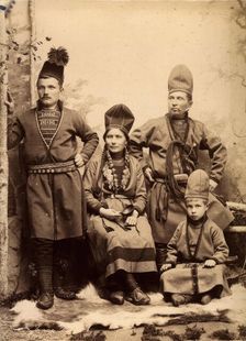 Group picture with four people wearing Sami folk costumes, 1912. Creator: Helene Edlund