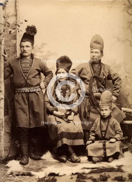 Group picture with four people wearing Sami folk costumes, 1912.  Creator: Helene Edlund.