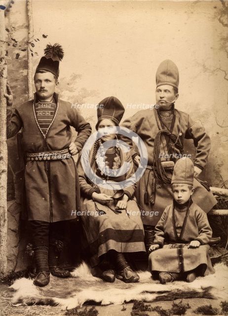 Group picture with four people wearing Sami folk costumes, 1912.  Creator: Helene Edlund.
