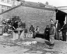 Gutting fish outside a warehouse in Whitby, North Yorkshire, 1959