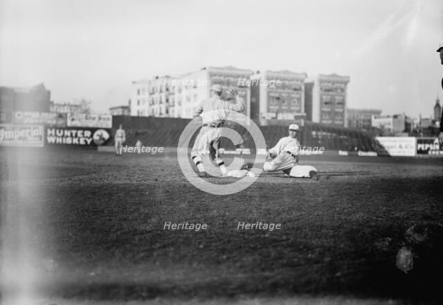 Guy Zinn, New York AL, sliding back into first base against Boston at Hilltop Park..., 1912. Creator: Bain News Service.