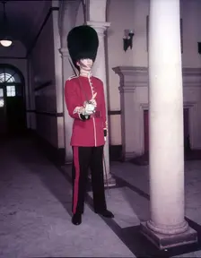 Guards officer in full dress uniform with bearskin on and sword drawn, London, Creator: Arthur Charles Kirby Ware