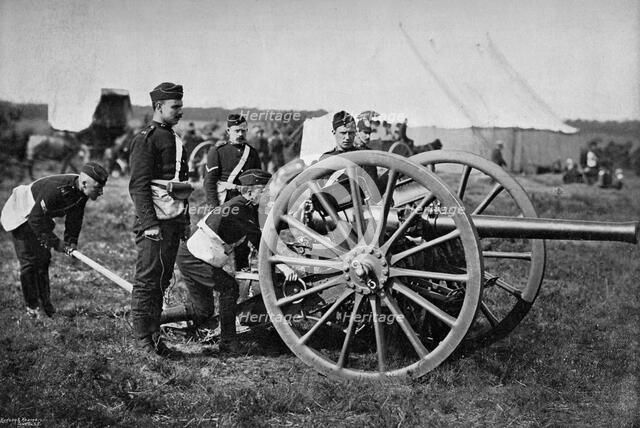 Gunners of field artillery drilling with a 12 pounder, 1895. Artist: Gregory & Co