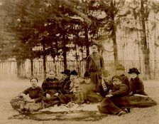 G.V. Iudina's Family with Their Guests in the Garden at the Dacha in Tarakanovo, 1907. Creator: Unknown