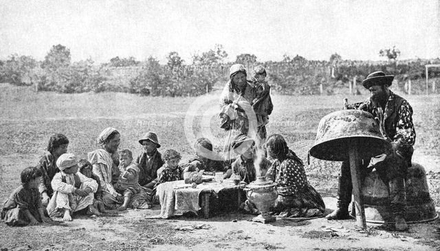 Gypsies mending a family cauldron, Hungary, 1922.Artist: AW Cutler