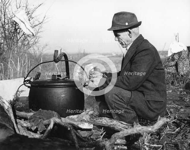 Gypsy man with cauldron, 1960s.